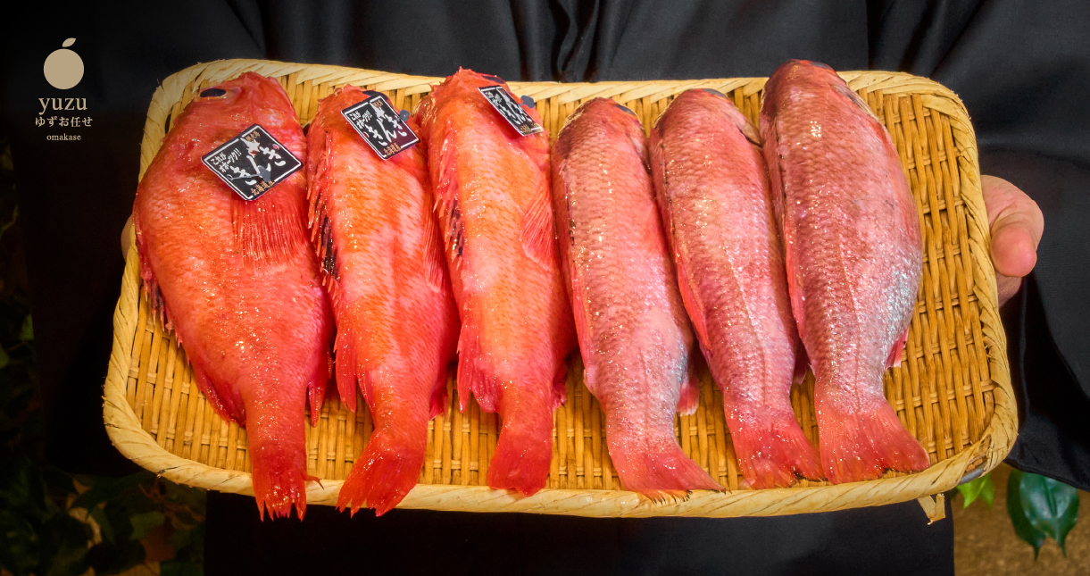 a group of red fish on a wicker tray