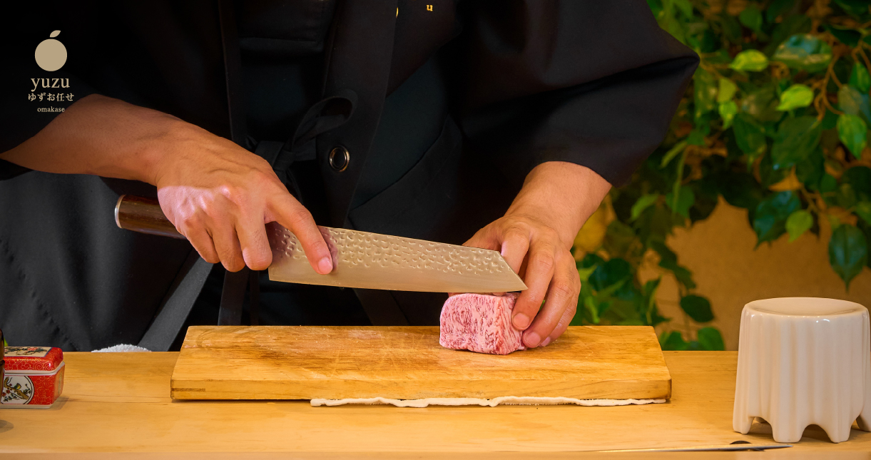 a person cutting meat on a cutting board