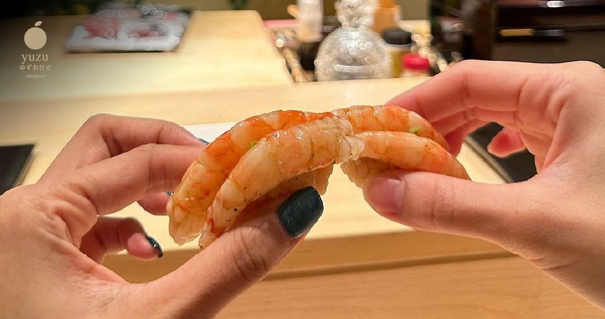 a person holding shrimp